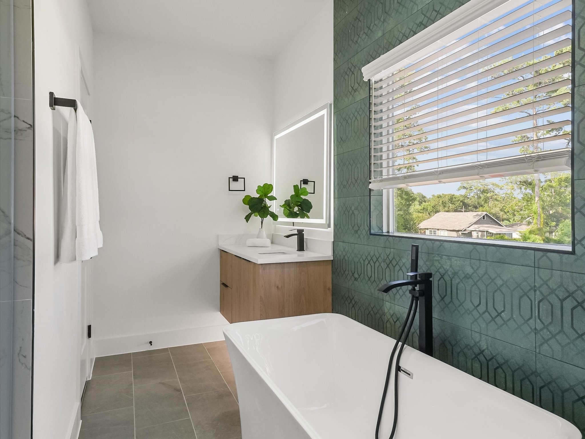 2598 West Tidwell Road Houston, TX 77091 - Photo 30 of 37 a living room with a couch and a large window