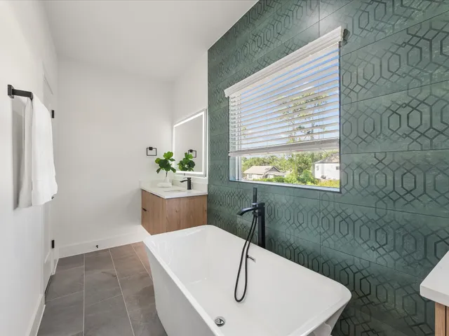 a bathroom with a sink a toilet and mirror