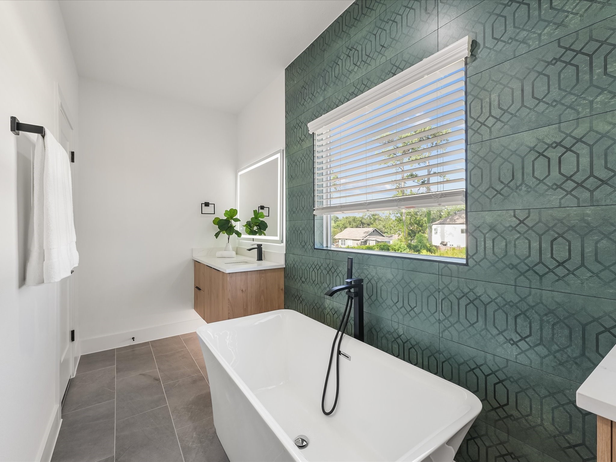 2598 West Tidwell Road Houston, TX 77091 - Photo 31 of 37 a bathroom with a sink a bathtub and window