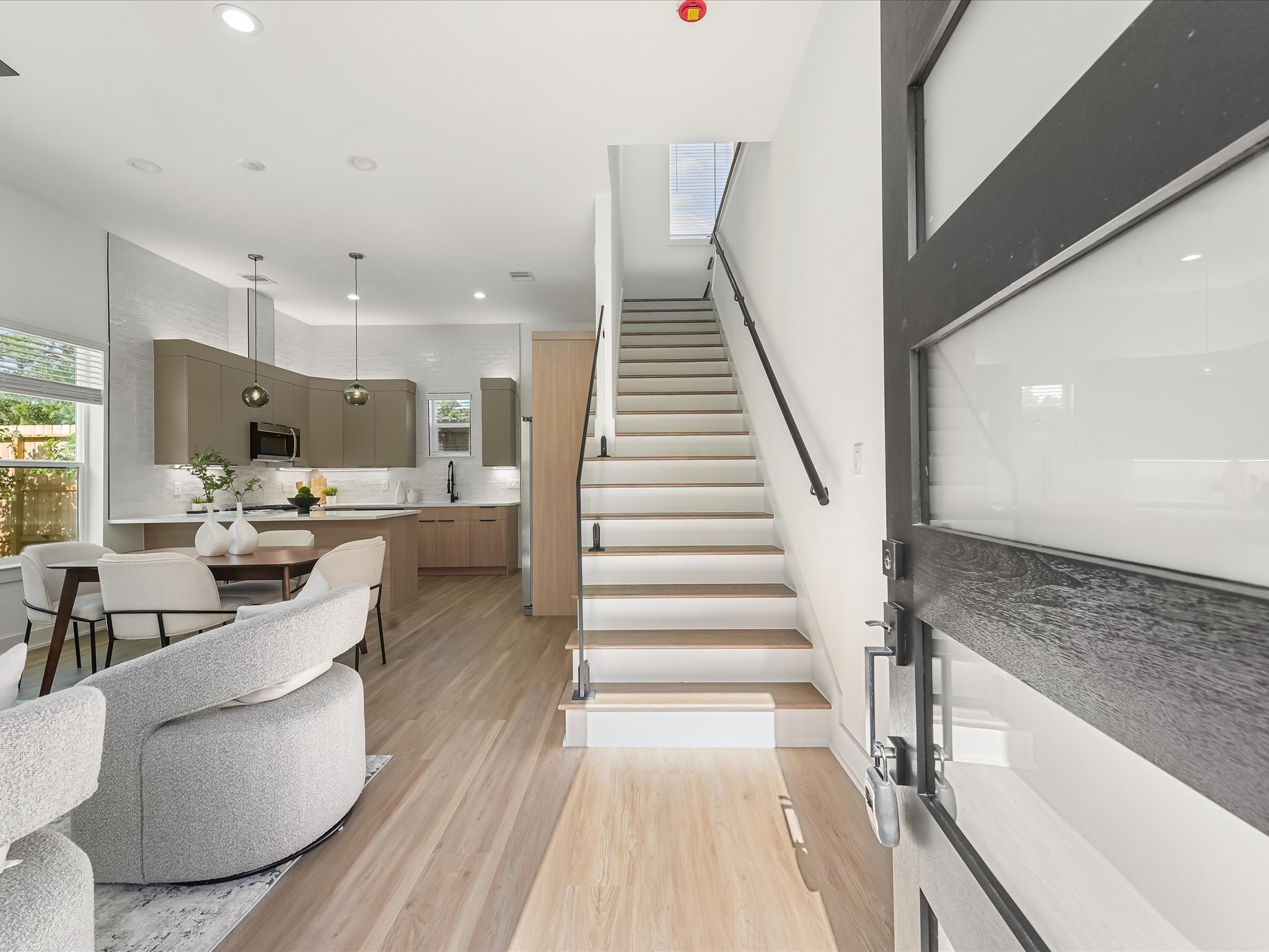 2598 West Tidwell Road Houston, TX 77091 - Photo 9 of 37 a living room with couches and kitchen view with wooden floor
