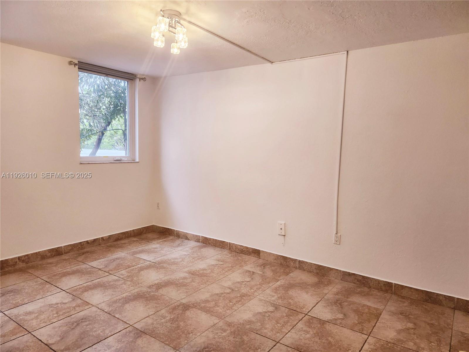 1666 West Avenue, Unit 312 Miami Beach, FL 33139 - Photo 11 of 42 an empty room with windows and fan