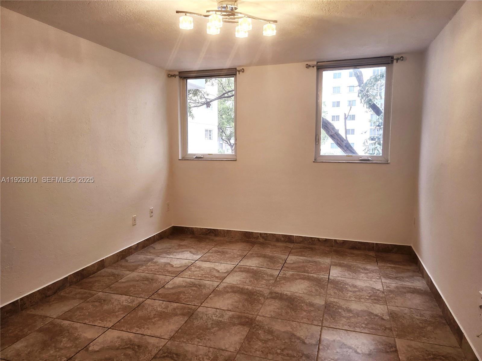 1666 West Avenue, Unit 312 Miami Beach, FL 33139 - Photo 15 of 42 an empty room with windows