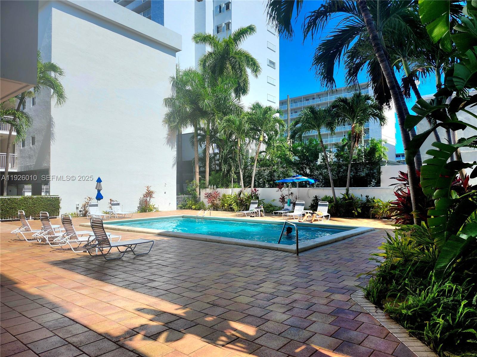1666 West Avenue, Unit 312 Miami Beach, FL 33139 - Photo 24 of 42 a view of a swimming pool with a patio