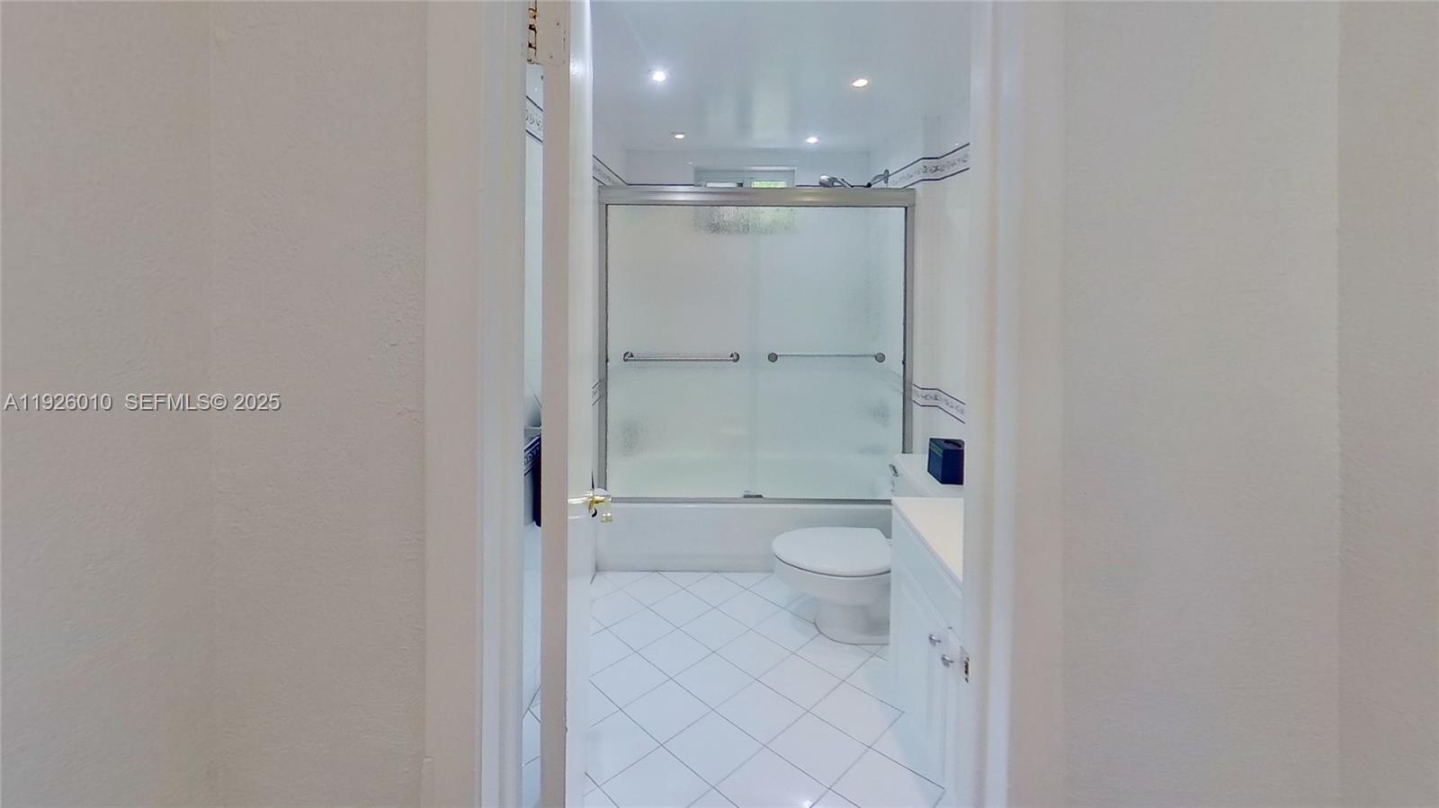 1666 West Avenue, Unit 312 Miami Beach, FL 33139 - Photo 3 of 42 a bathroom with a granite countertop shower and a toilet