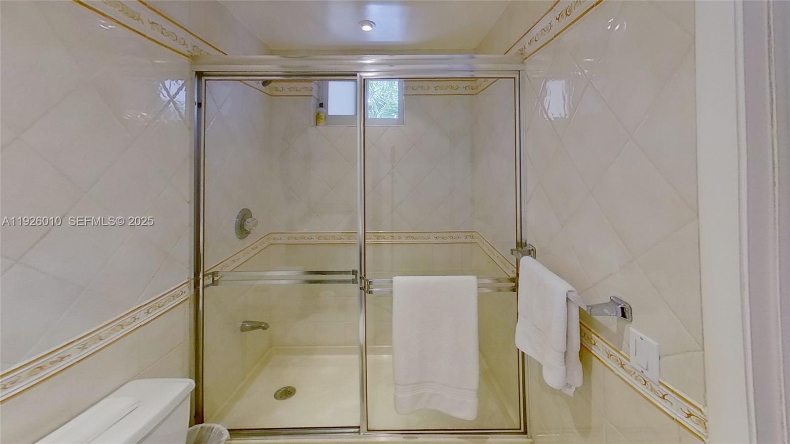 1666 West Avenue, Unit 312 Miami Beach, FL 33139 - Photo 4 of 42 a bathroom with a shower and a glass door