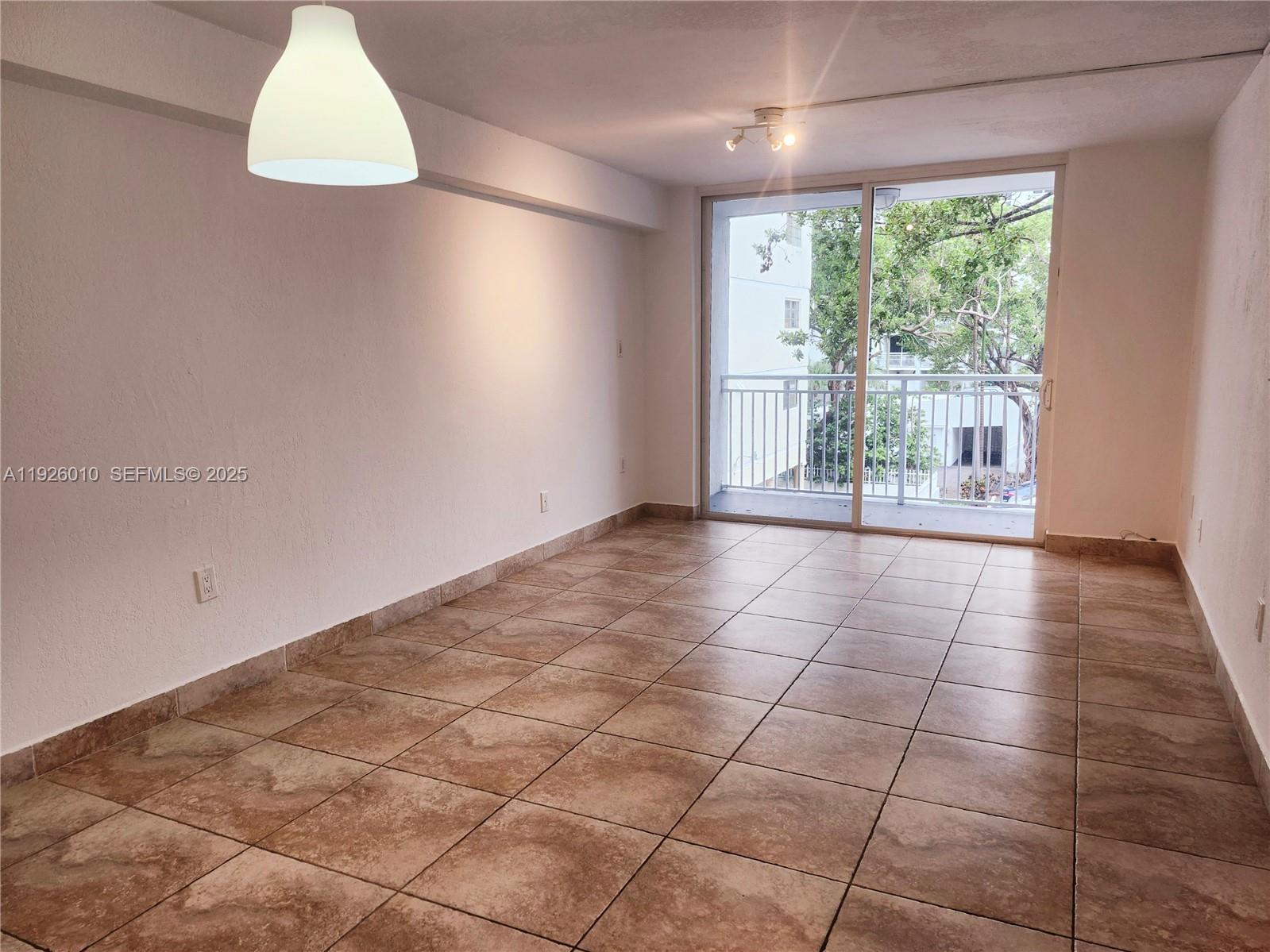 1666 West Avenue, Unit 312 Miami Beach, FL 33139 - Photo 10 of 42 a view of an empty room with windows