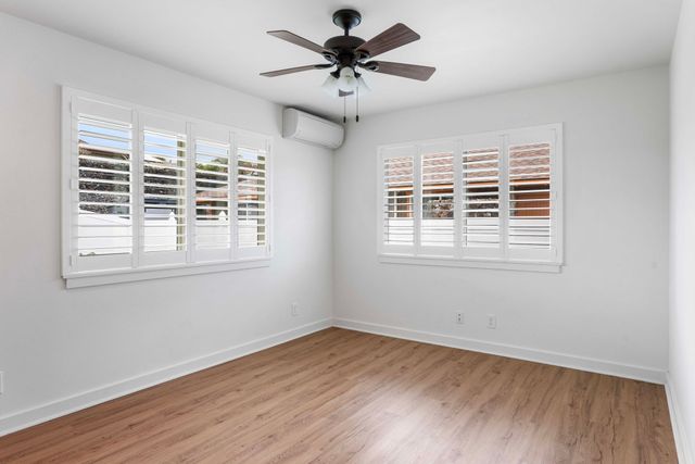 a view of a livingroom with a ceiling fan and window
