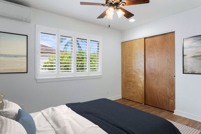 a bedroom with a large bed and a large window