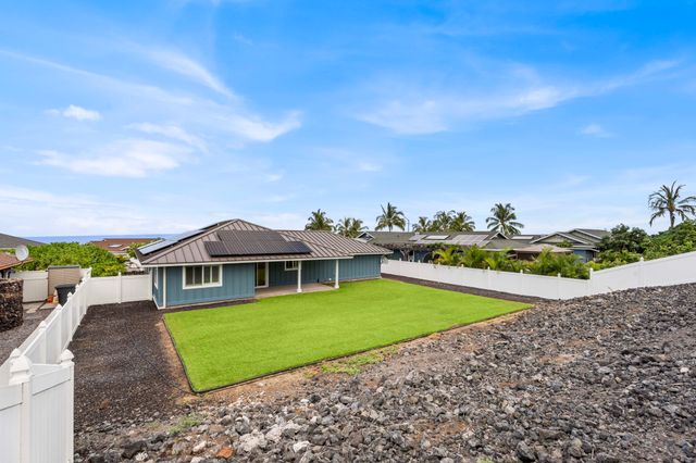 a view of a house with a yard and sitting area