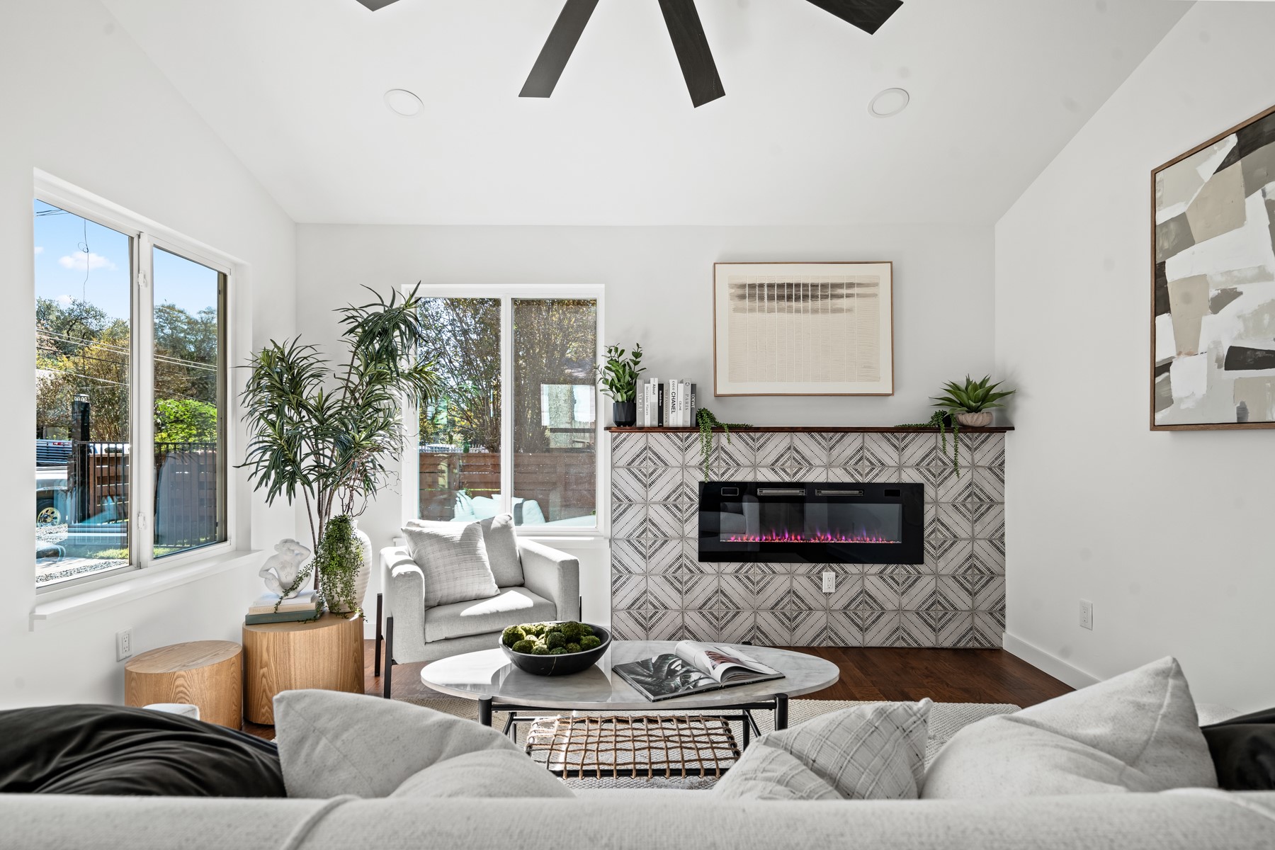 1006 Cherico Street, Unit 2 Austin, TX 78702 - Photo 3 of 7 Living area with a ceiling fan, wood finished floors, lofted ceiling, and a glass covered fireplace