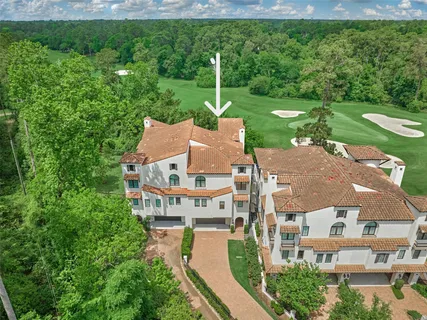 an aerial view of a house with a big yard