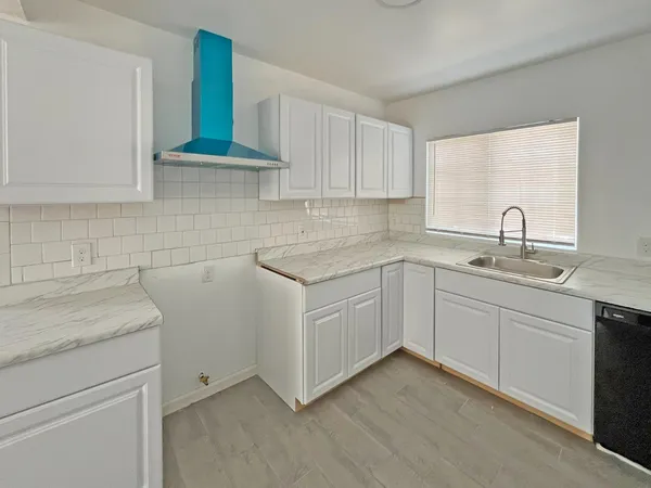 a kitchen with a sink stove and cabinets