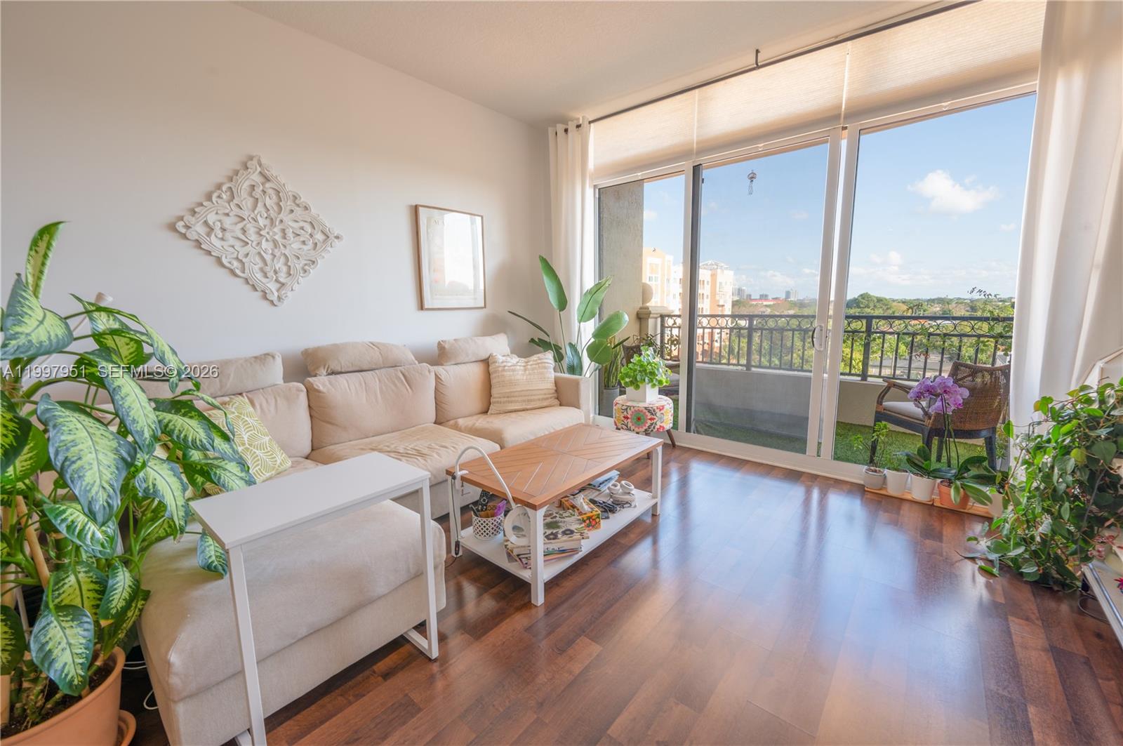 3232 Southwest 22nd Terrace, Unit 607 Miami, FL 33145 - Photo 1 of 20 a living room with furniture and a potted plant