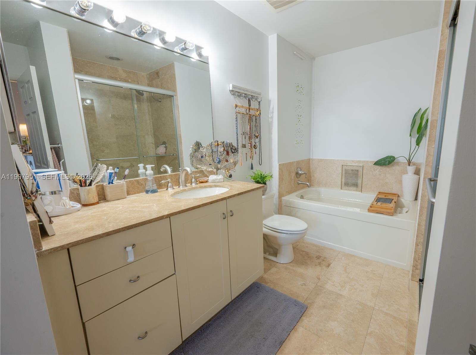 3232 Southwest 22nd Terrace, Unit 607 Miami, FL 33145 - Photo 11 of 20 a bathroom with a granite countertop sink mirror vanity and toilet