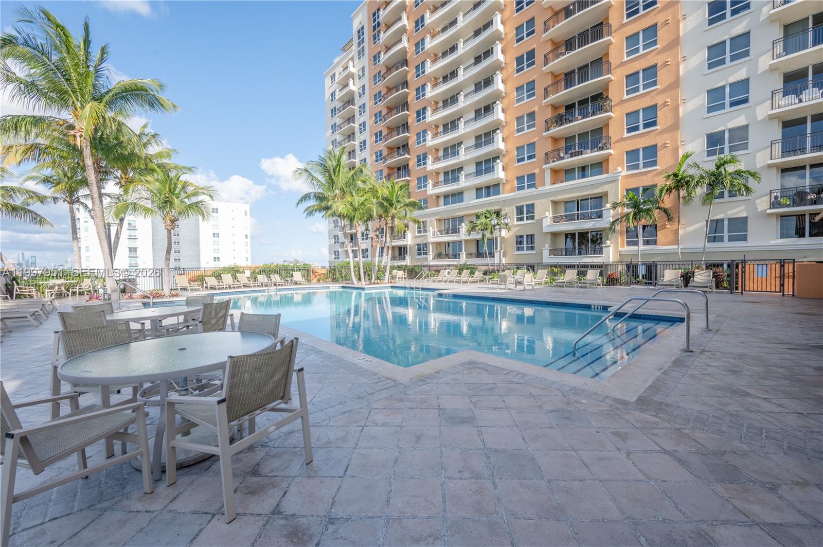 3232 Southwest 22nd Terrace, Unit 607 Miami, FL 33145 - Photo 19 of 20 a view of swimming pool with outdoor seating and plants