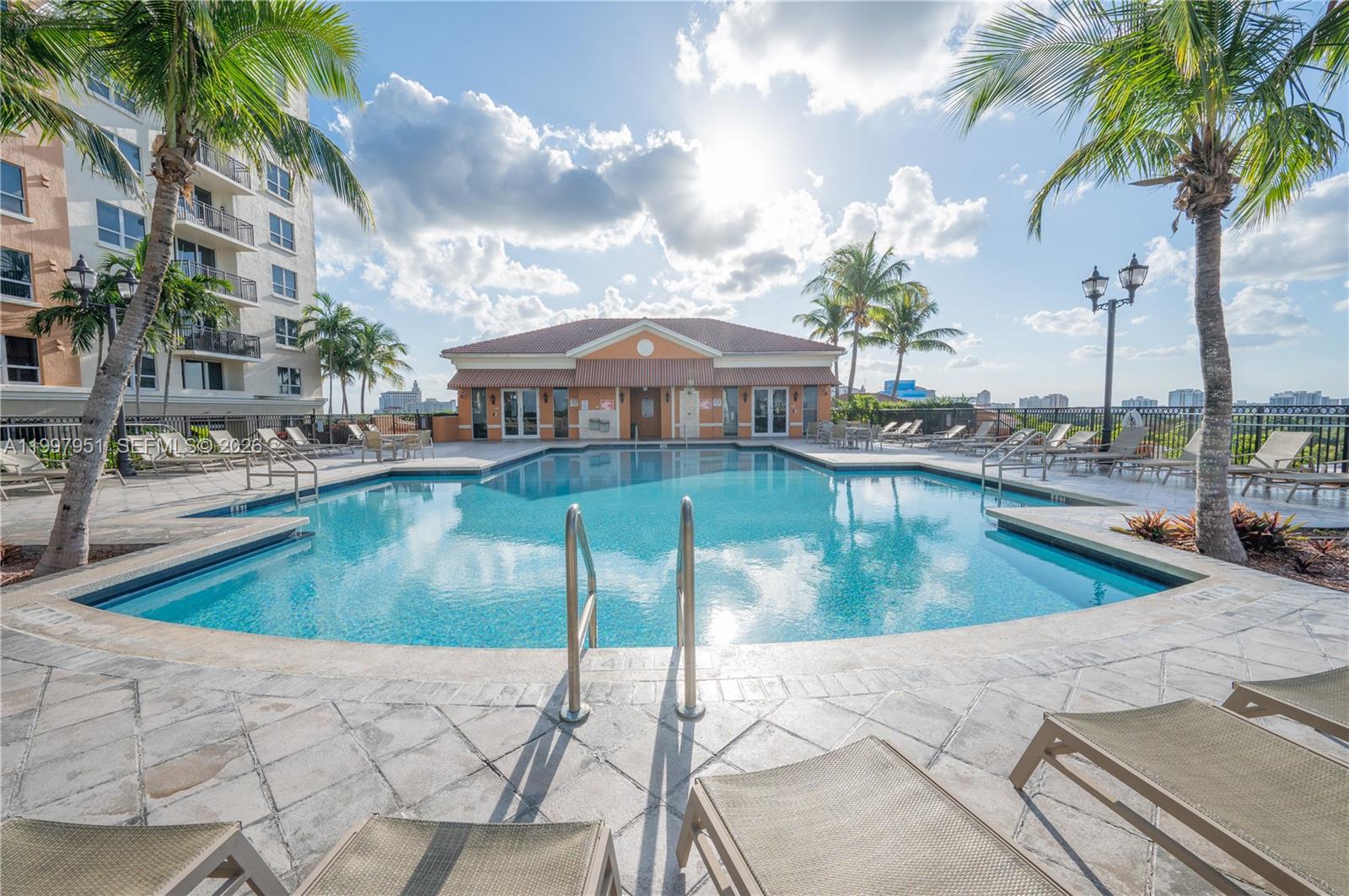 3232 Southwest 22nd Terrace, Unit 607 Miami, FL 33145 - Photo 20 of 20 a view of a swimming pool with a lounge chairs