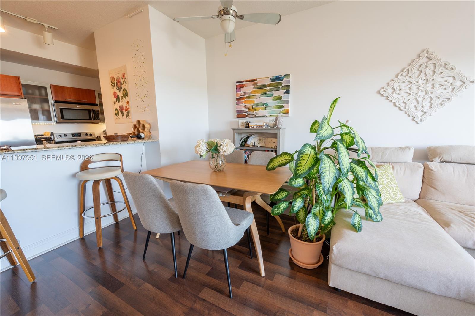 3232 Southwest 22nd Terrace, Unit 607 Miami, FL 33145 - Photo 5 of 20 a dining room with furniture potted plants and wooden floor