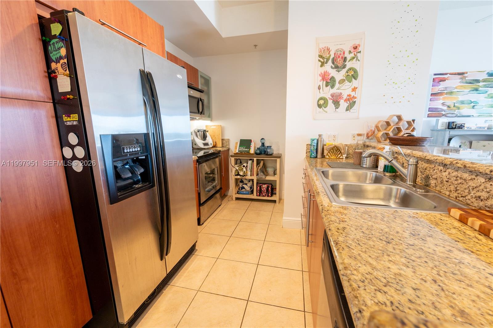 3232 Southwest 22nd Terrace, Unit 607 Miami, FL 33145 - Photo 6 of 20 a kitchen with stainless steel appliances granite countertop a refrigerator and a stove