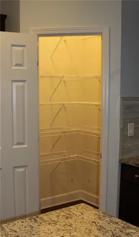 a bathroom with a granite countertop bathtub sink vanity mirror and toilet