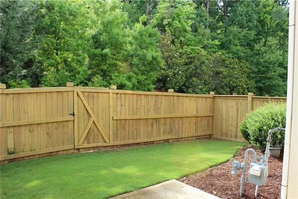 a view of a backyard with a wooden fence