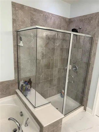 a bathroom with a shower and a sink