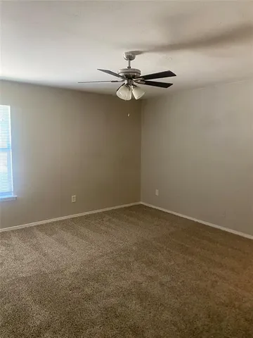 an empty room with closet and wooden floor