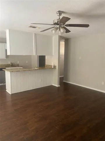 a view of a kitchen with a sink and a refrigerator