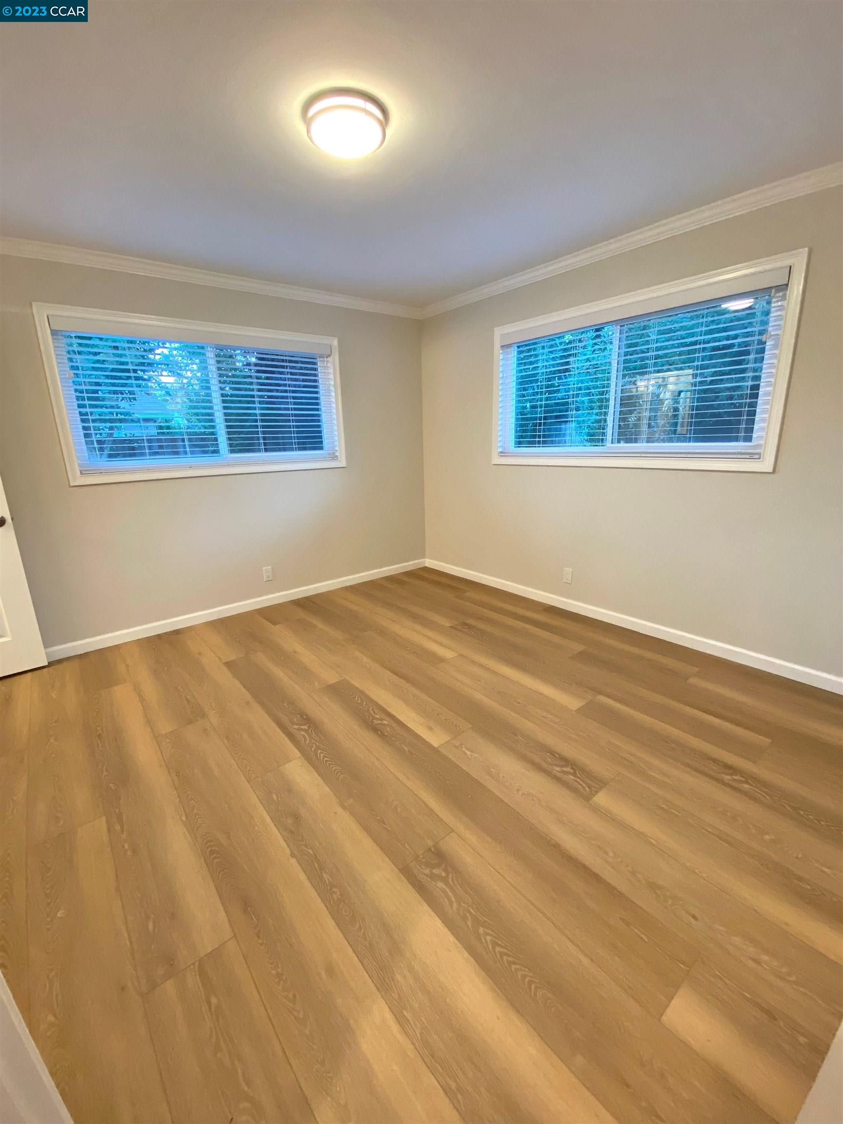 959 Duar Drive Concord, CA 94518 - Photo 12 of 14 a view of an empty room with wooden floor and a window