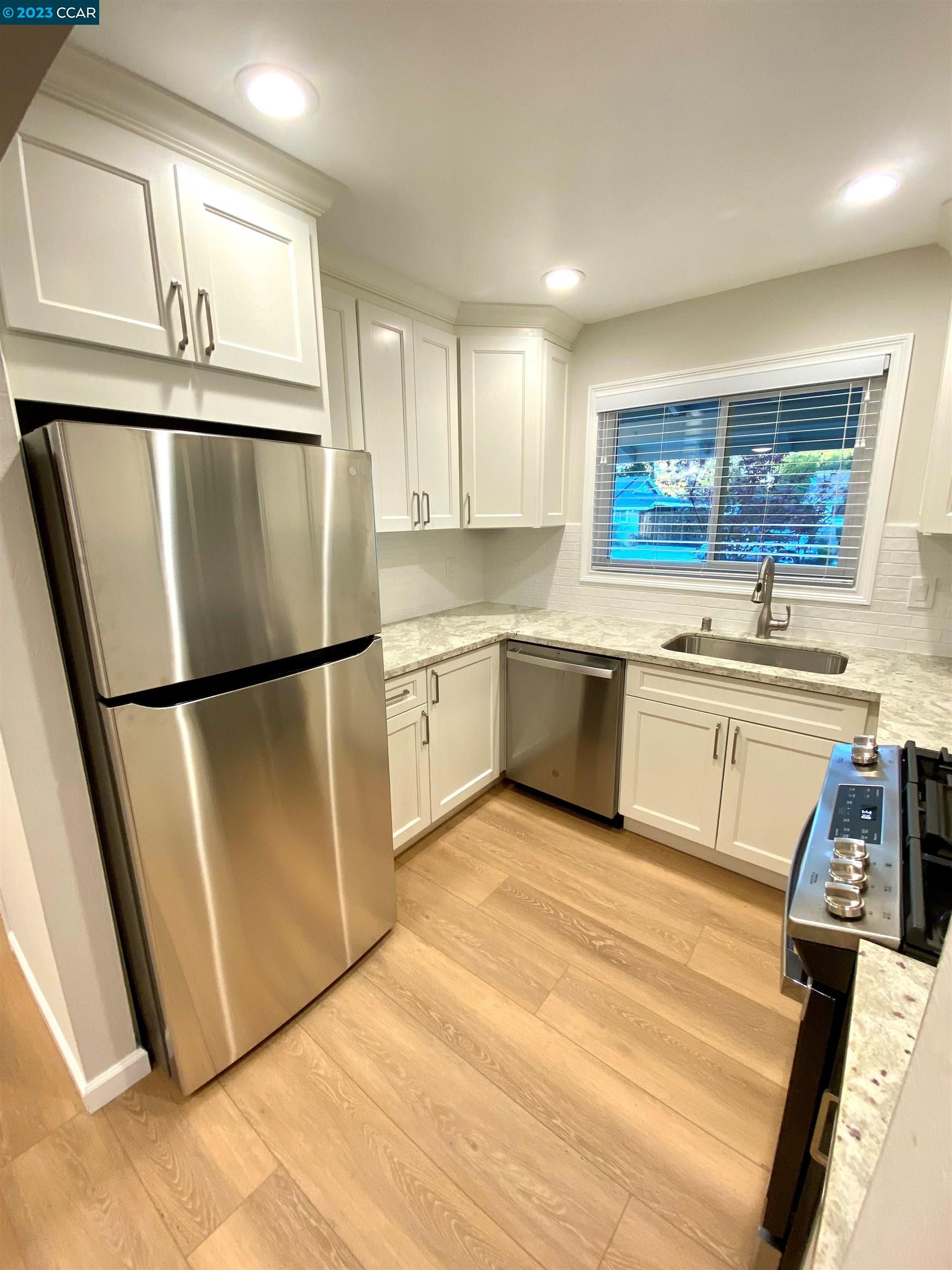 959 Duar Drive Concord, CA 94518 - Photo 4 of 14 a kitchen with stainless steel appliances granite countertop a refrigerator sink and cabinets