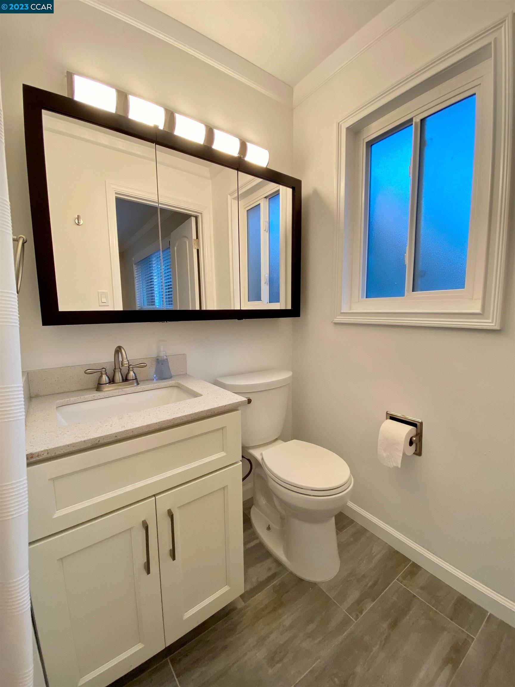959 Duar Drive Concord, CA 94518 - Photo 10 of 14 a bathroom with a granite countertop toilet sink and mirror