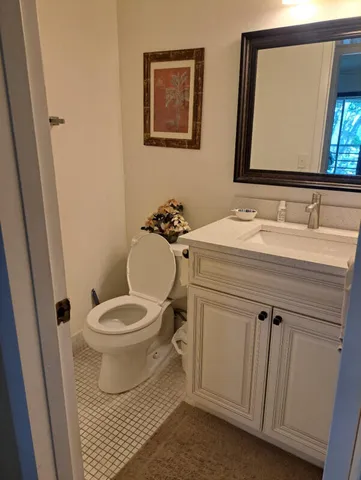 a bathroom with a sink toilet and mirror