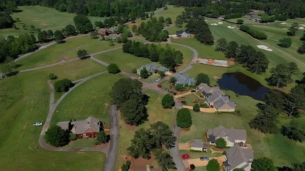 an aerial view of a house with a yard