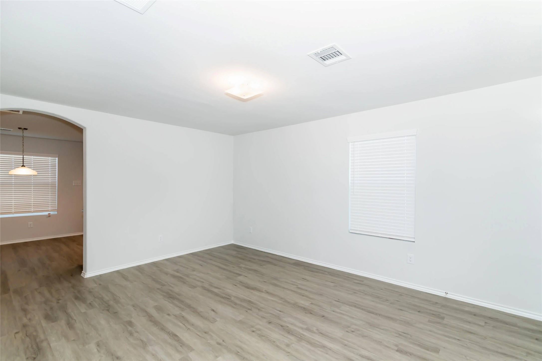 22406 Porter Mountain Trail Porter, TX 77365 - Photo 4 of 11 an empty room with wooden floor and windows