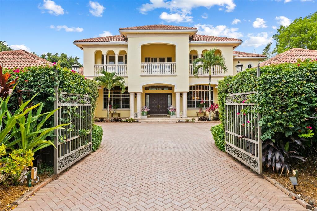 12794 Stonebrook Drive Davie, FL 33330 - Photo 2 of 45 a front view of a house with a garden
