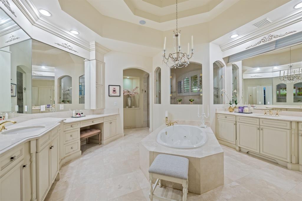 12794 Stonebrook Drive Davie, FL 33330 - Photo 25 of 45 a spacious en suite bathroom with a sink a chandelier a large mirror and a shower