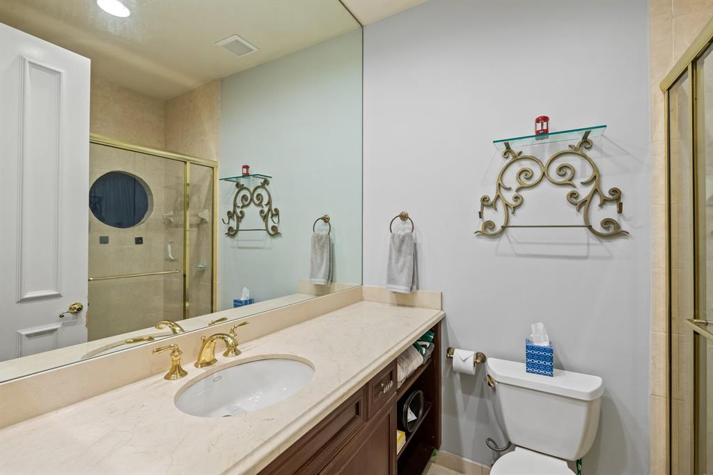 12794 Stonebrook Drive Davie, FL 33330 - Photo 38 of 45 a bathroom with a granite countertop sink a toilet and a mirror