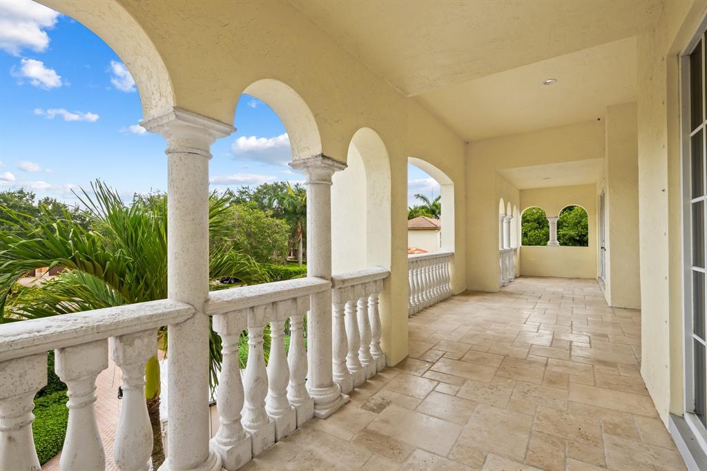 12794 Stonebrook Drive Davie, FL 33330 - Photo 41 of 45 a view of a house with large windows and plants