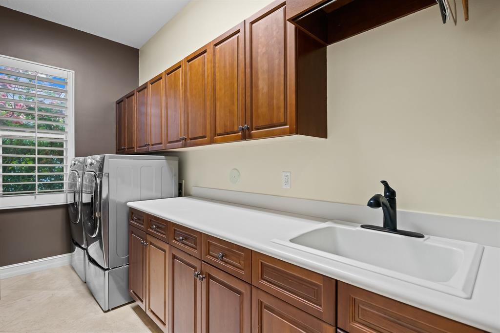 12794 Stonebrook Drive Davie, FL 33330 - Photo 44 of 45 a kitchen with a refrigerator and a sink