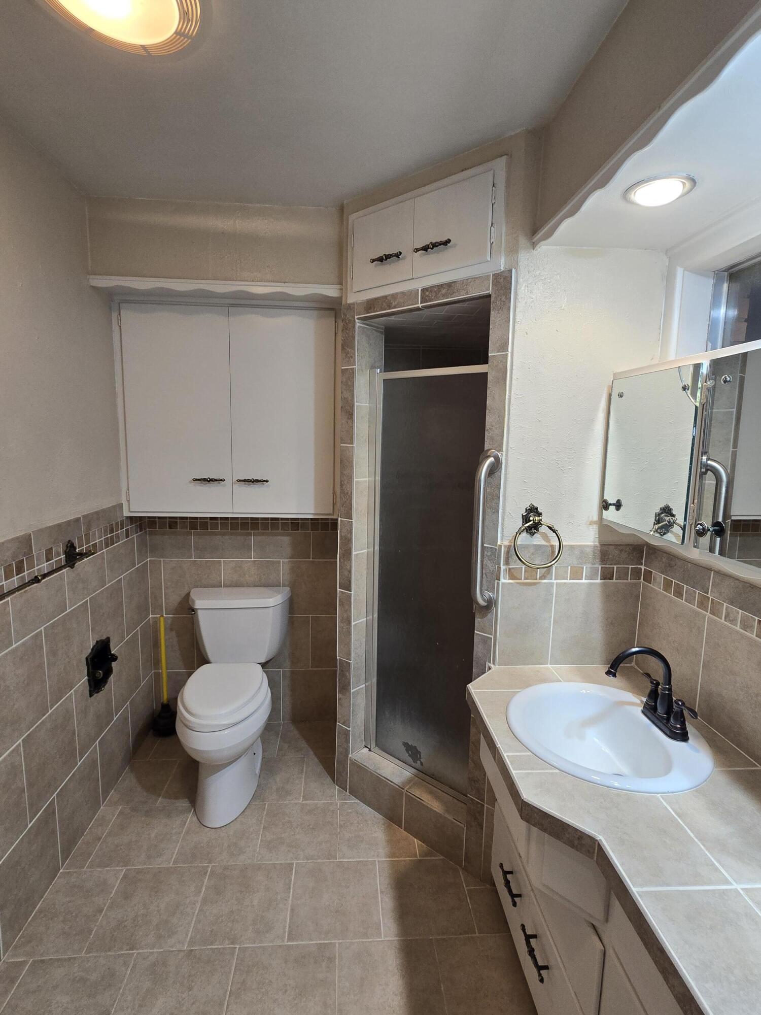 2229 South 6th Street Lamesa, TX 79331 - Photo 12 of 27 a bathroom with a sink toilet and shower