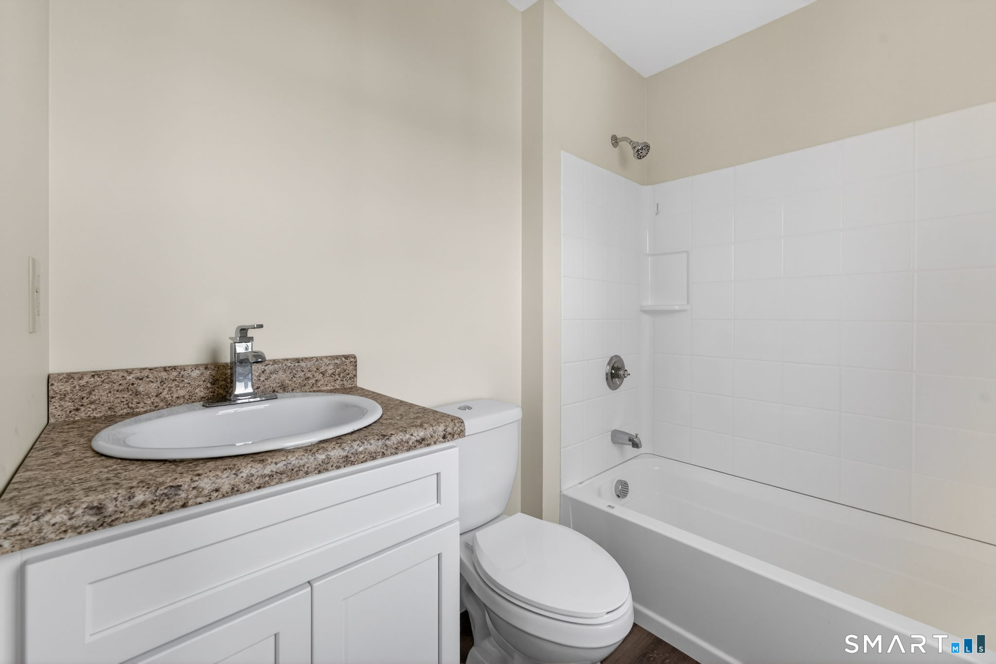 570 Zion Street Hartford, CT 06106 - Photo 27 of 40 a bathroom with a granite countertop sink a toilet and shower