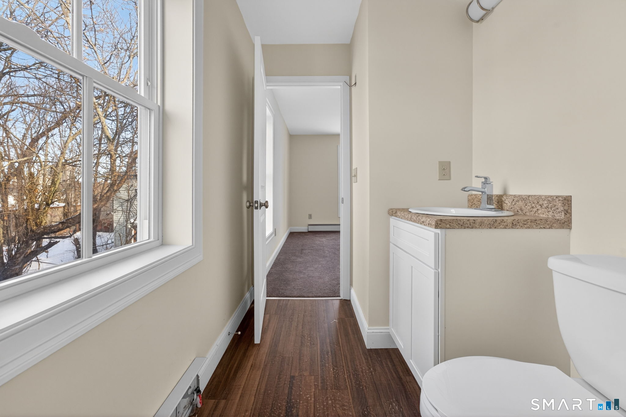 570 Zion Street Hartford, CT 06106 - Photo 28 of 40 a bathroom with a sink toilet and window