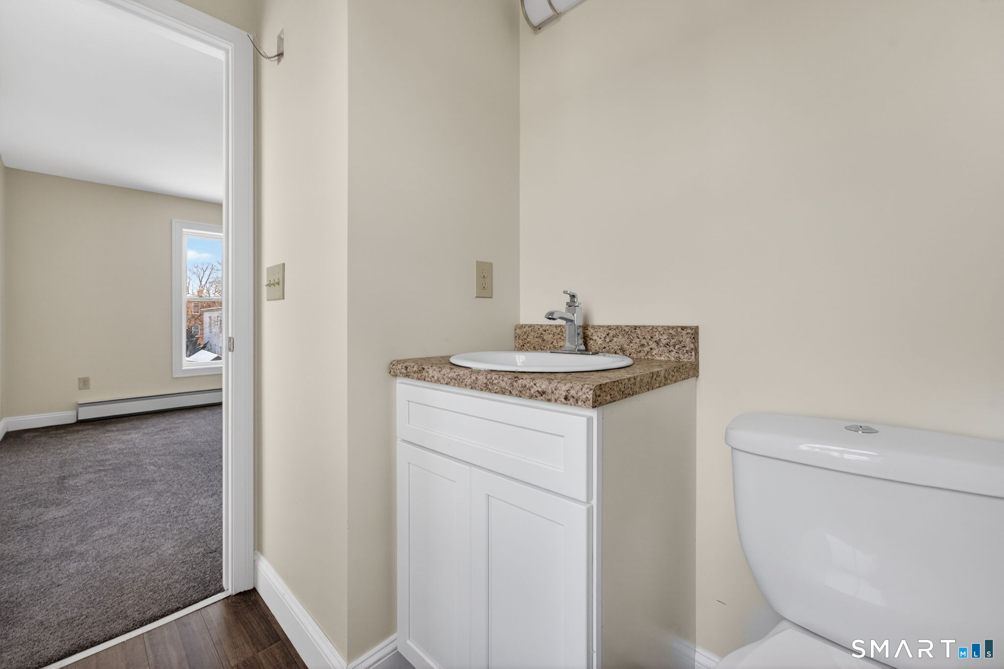 570 Zion Street Hartford, CT 06106 - Photo 29 of 40 a bathroom with a toilet a sink and a mirror