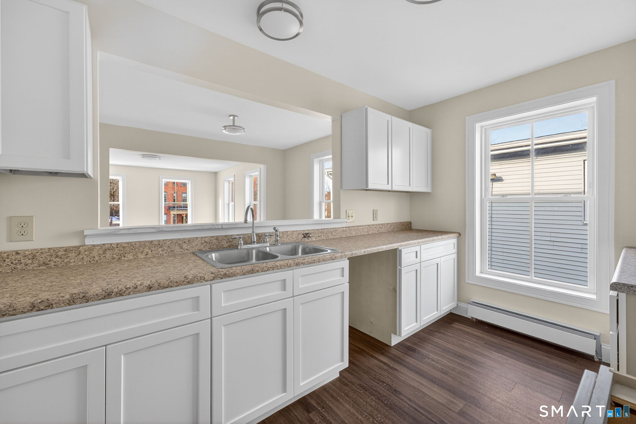 570 Zion Street Hartford, CT 06106 - Photo 3 of 40 a kitchen with granite countertop white cabinets and white appliances