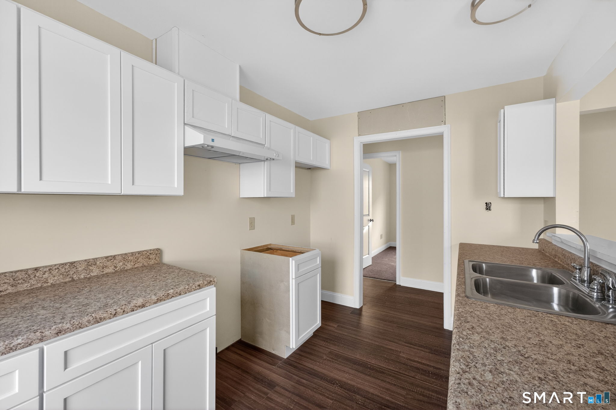 570 Zion Street Hartford, CT 06106 - Photo 37 of 40 a kitchen with stainless steel appliances granite countertop a sink a stove a dining table and chairs with wooden floor