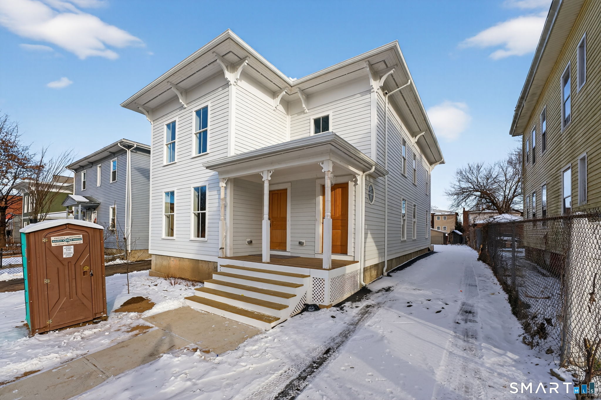 570 Zion Street Hartford, CT 06106 - Photo 40 of 40 a view of a white house with large windows and a road