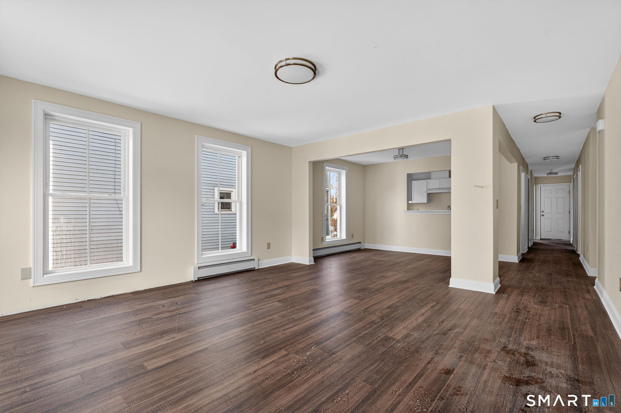 570 Zion Street Hartford, CT 06106 - Photo 5 of 40 a view of an empty room with wooden floor and a window