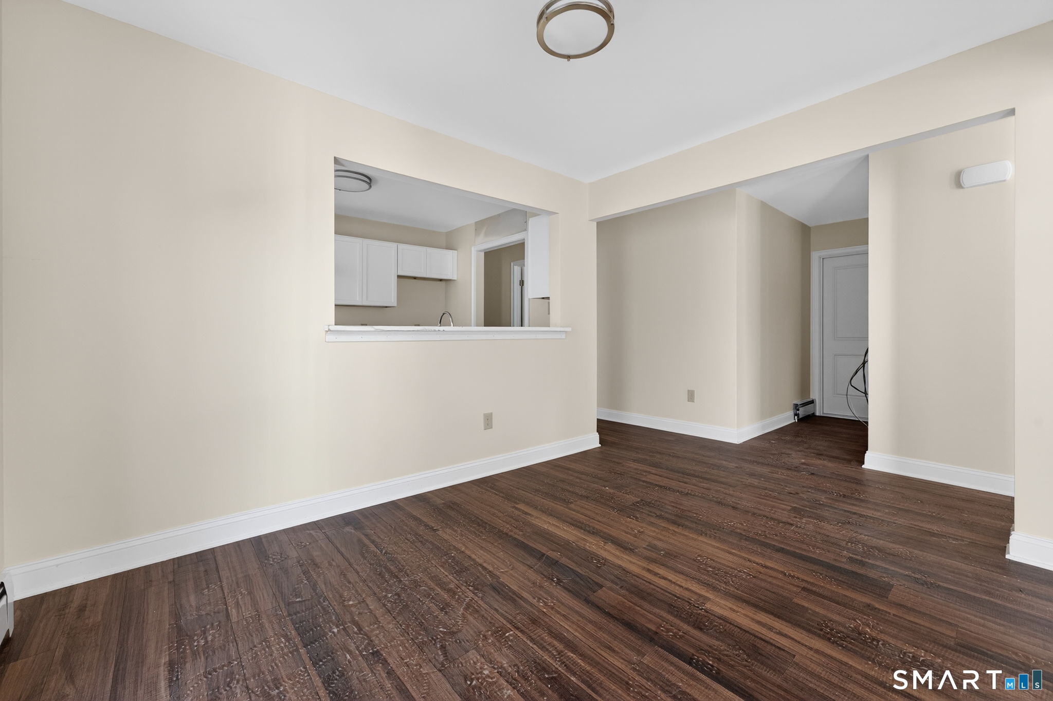 570 Zion Street Hartford, CT 06106 - Photo 9 of 40 a view of an empty room with wooden floor and a window