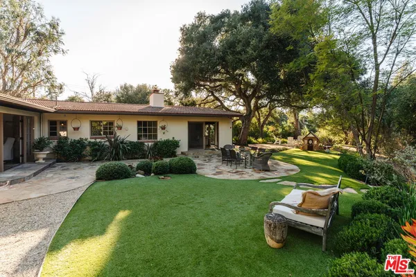 a view of a house with backyard porch and sitting area