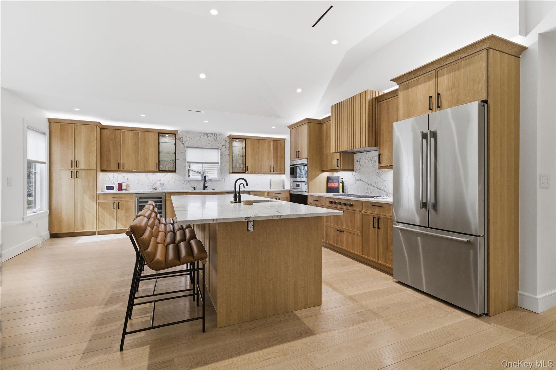 21 Dunhill Road New Hyde Park, NY 11040 - Photo 7 of 20 a kitchen with stainless steel appliances a refrigerator and a stove top oven