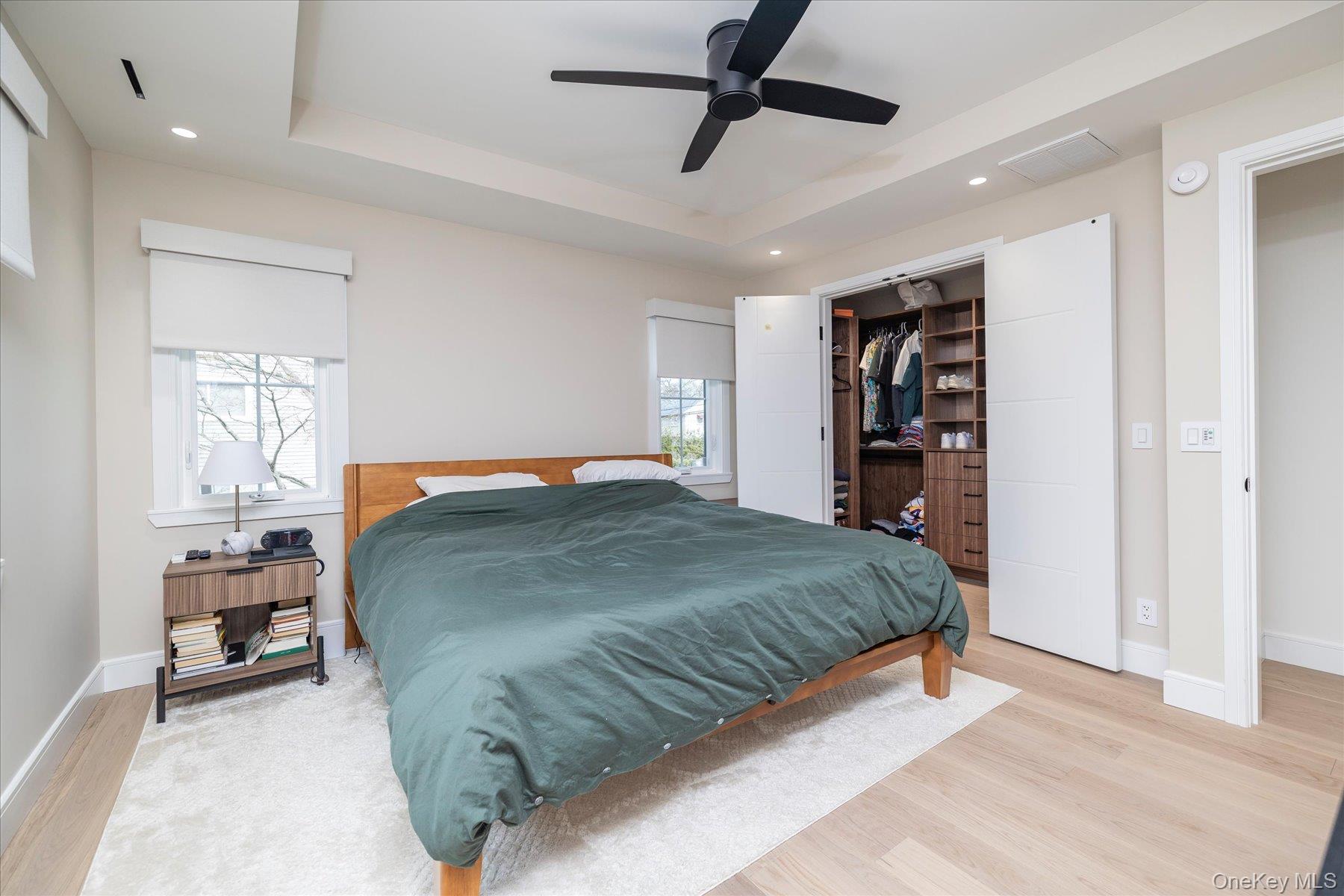 21 Dunhill Road New Hyde Park, NY 11040 - Photo 9 of 20 a bedroom with a large bed and a chandelier